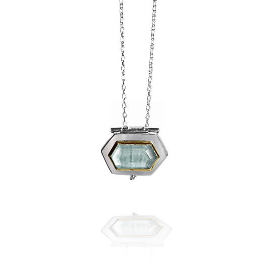 Hexagonal locket necklace with hexagonal aquamarine and chain on a white background
