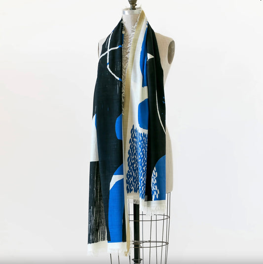 Mannequin wearing a black and blue patterned scarf on a white background