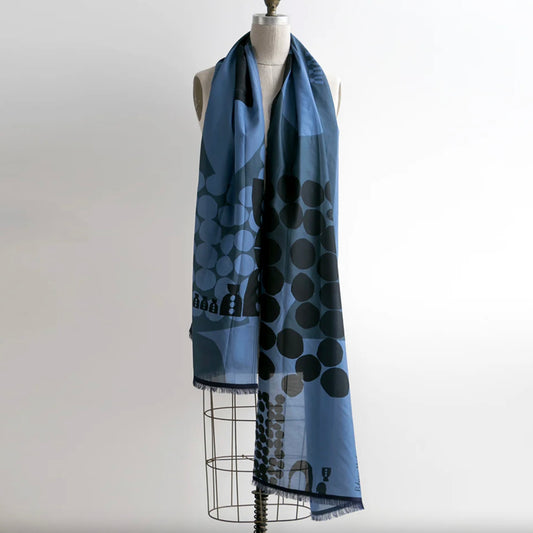 Blue scarf with black polka dot pattern on a mannequin against a white background