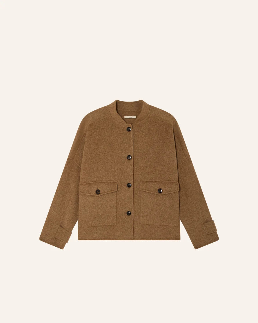 A brown cropped jacket with a button front, long sleeves, and two front flap pockets, shown on a plain light beige background.