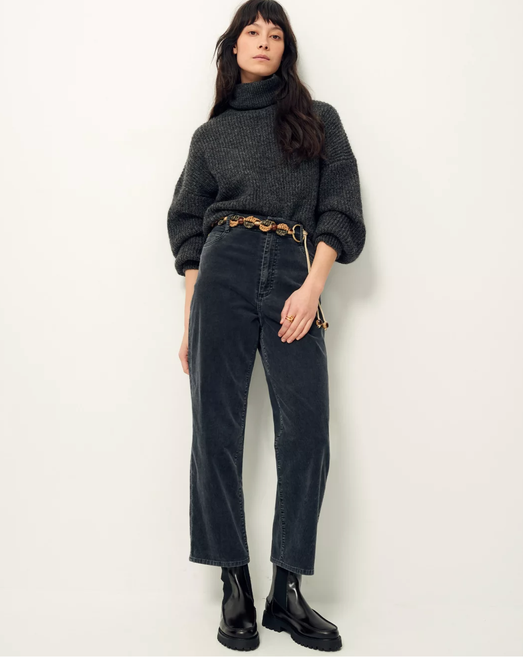 Front image of woman wearing soft black corduroy cropped pants.