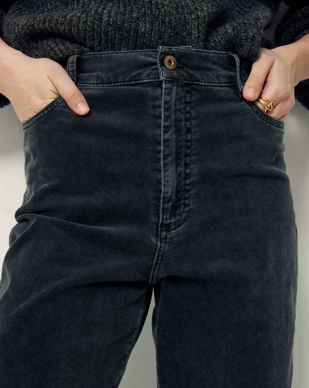 Front detail of soft black corduroy pants.