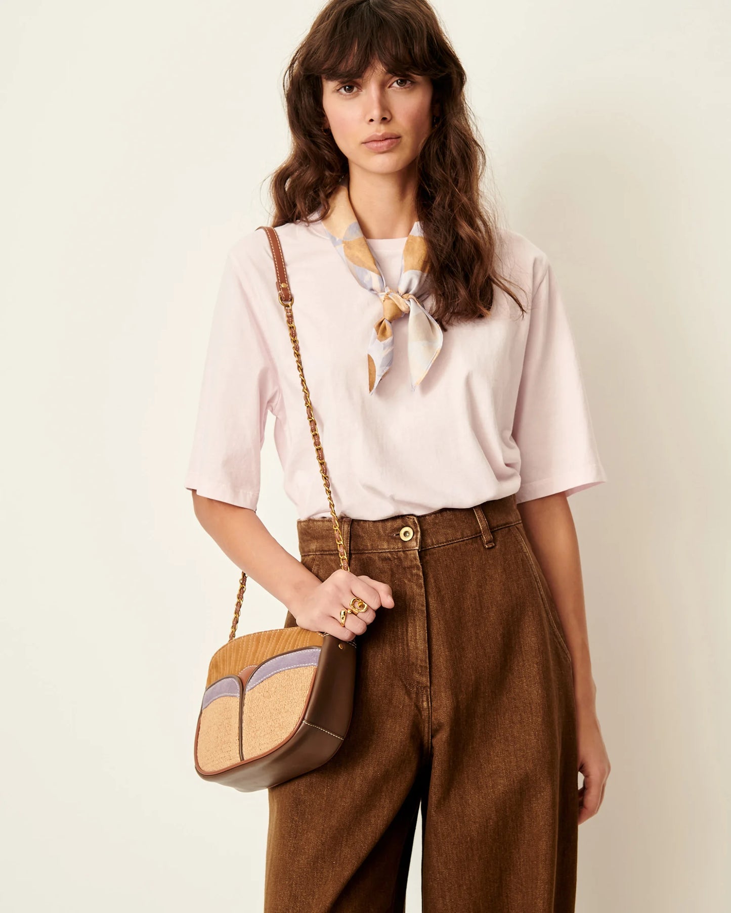 Model wearing a Rose T-shirt with elbow length sleeves, knotted scarf and a handbag. White background