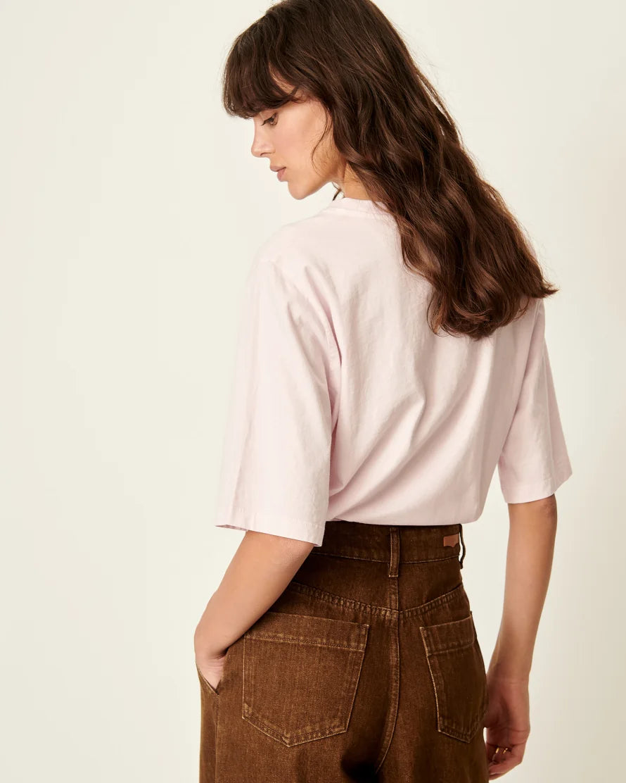 Back view of a model wearing a Rose T-shirt with elbow length sleeves. White background
