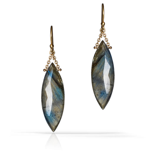 A pair of drop earrings featuring marquise-cut labradorite gemstones with a shimmering blue-gray color, suspended from antique bronze hooks with delicate chain details, set against a plain white background.