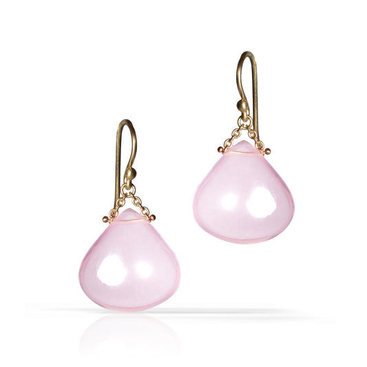 A pair of teardrop-shaped pink stone dangle earrings with antique gold hooks and chain details, shown on a clean white background with a soft reflection.