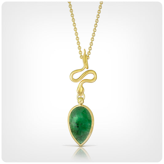 A gold pendant necklace featuring a teardrop-shaped green gemstone pendant in a gold bezel setting, suspended from a delicate gold chain against a light gray gradient background.
