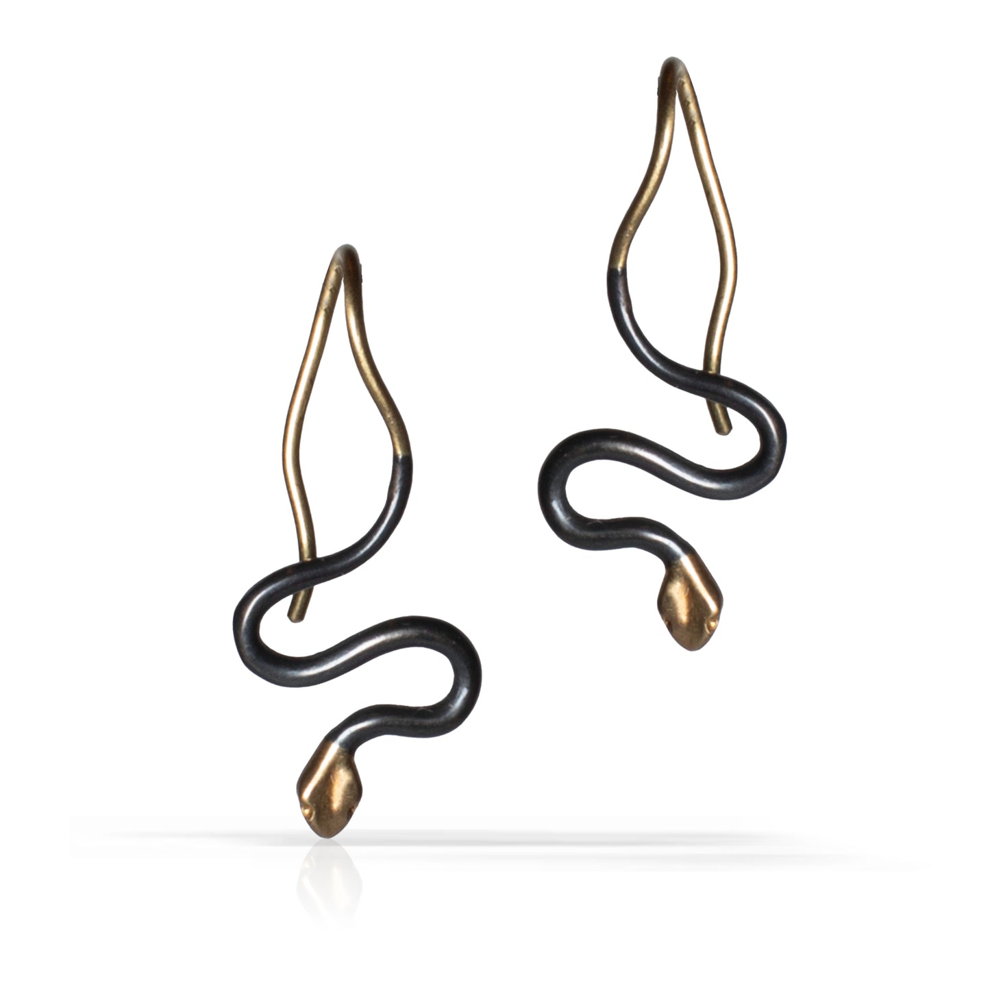 A pair of snake-shaped drop earrings with an oxidized sterling silver finish and gold tips and hooks, shown on a clean white background.