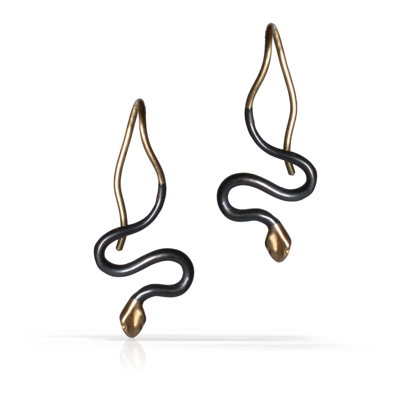 A pair of snake-shaped drop earrings with an oxidized sterling silver finish and gold tips and hooks, shown on a clean white background.