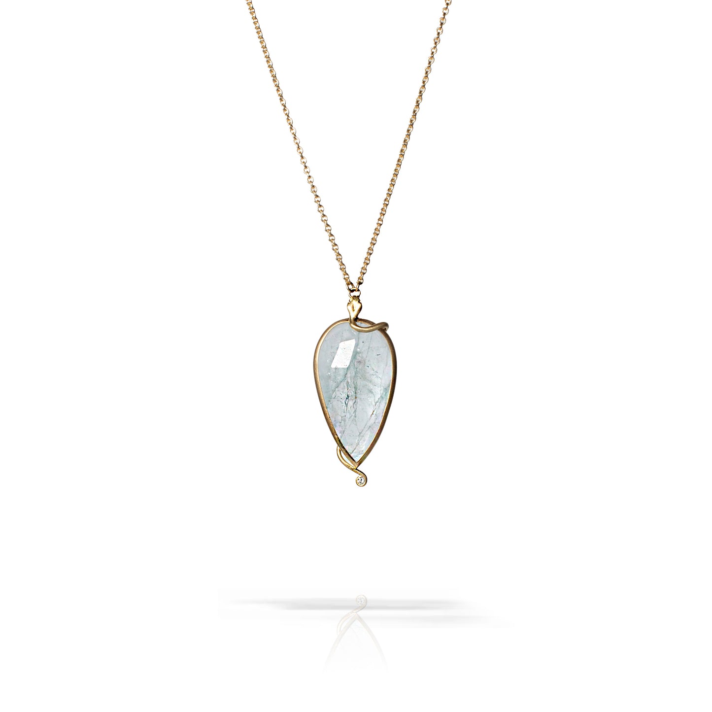 A teardrop-shaped pendant necklace featuring a clear, fibrous gemstone in a gold-toned bezel setting on a delicate chain, shown against a white background with a soft reflection below.