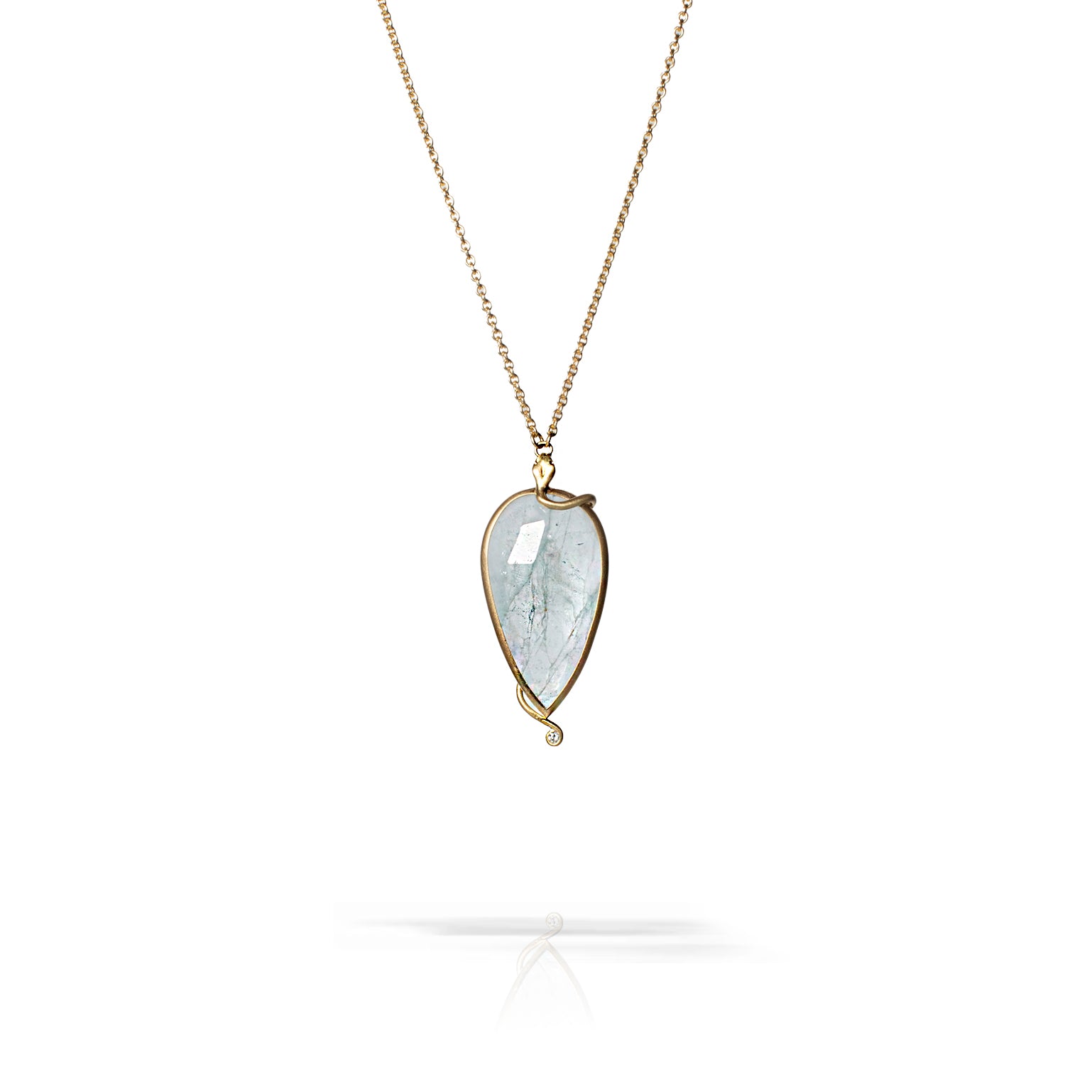 A teardrop-shaped pendant necklace featuring a clear, fibrous gemstone in a gold-toned bezel setting on a delicate chain, shown against a white background with a soft reflection below.