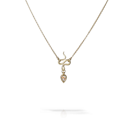 A delicate necklace featuring a gold infinity symbol pendant with a small heart-shaped drop containing a clear gemstone, suspended from a fine silver-toned chain on a white background.