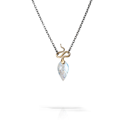 A delicate necklace featuring a small gold snake wrapping around a teardrop-shaped white marbled gemstone pendant, suspended from a dark silver chain on a white background.