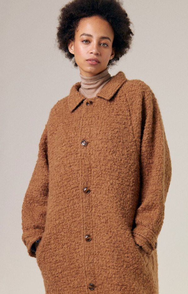 wool boucle 5 button front coat in Tobacco with collar, raglan sleeve and one button flap on cuff. worn with a taupe turtleneck