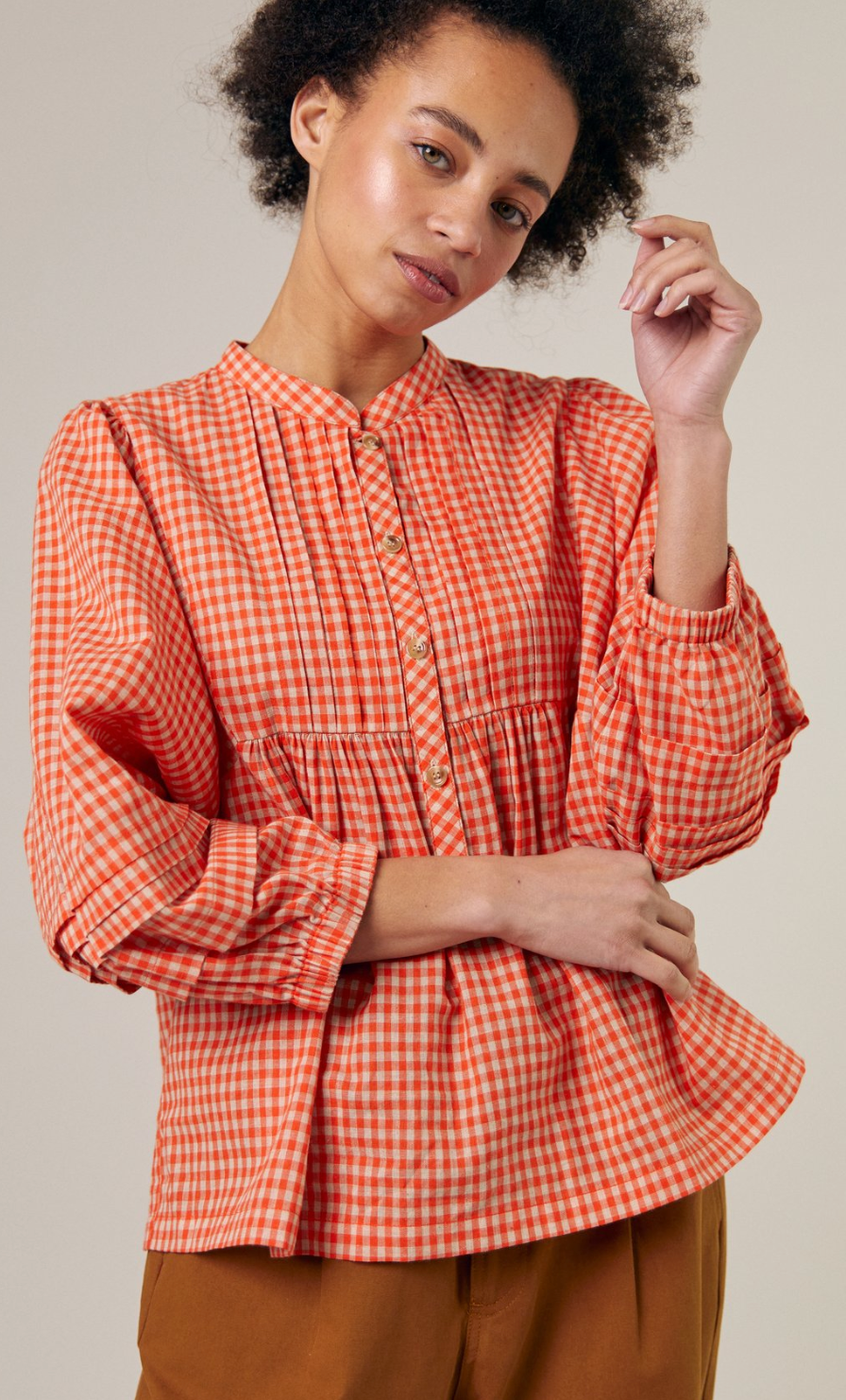 Orange check 5 button front shirt with stand up collar, 3/4 sleeve with 3 pleats and a gathered cuff