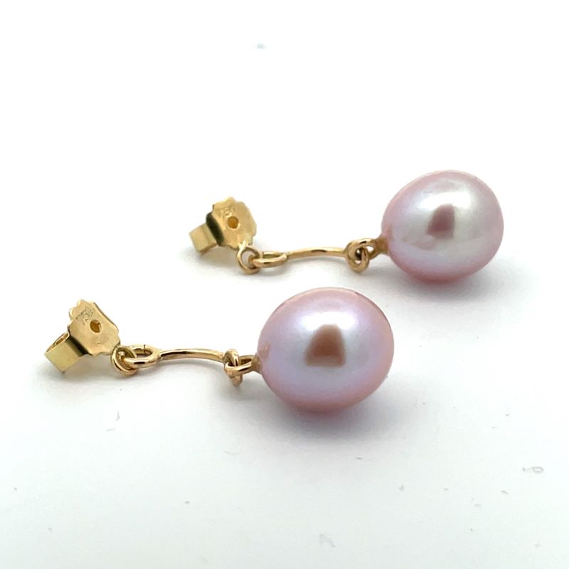 A pair of gold drop earring pendants featuring round, lustrous light pink freshwater pearls, displayed on a clean white background.