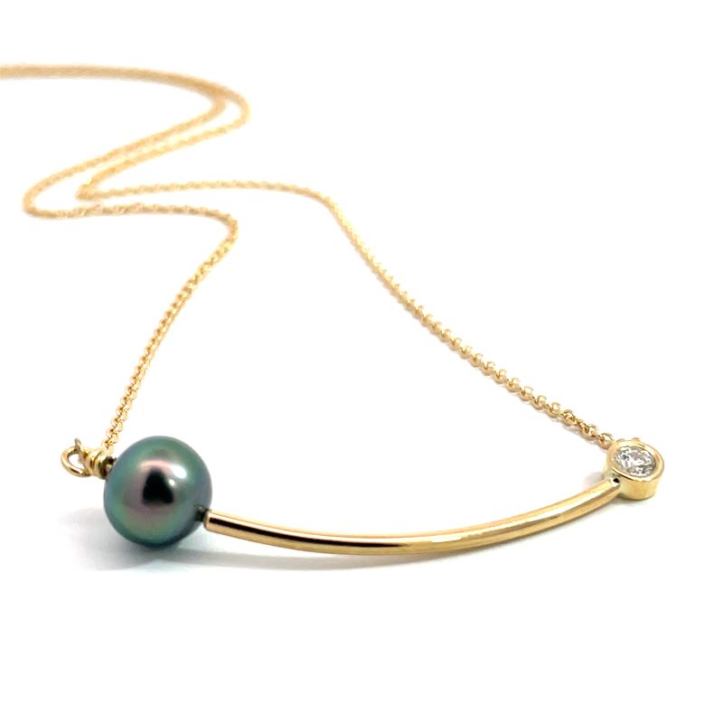 A gold necklace featuring a curved bar pendant with a dark green iridescent pearl and a small round diamond, shown on a white background.