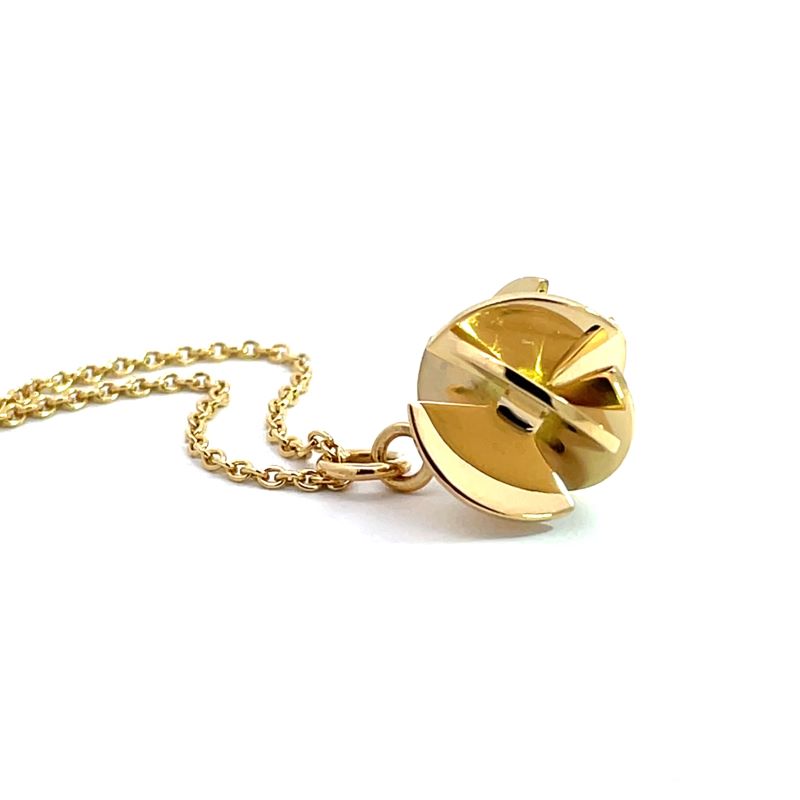 A gold pendant necklace featuring a stylized, fan sphere pendant on a delicate gold chain, photographed against a seamless white background.