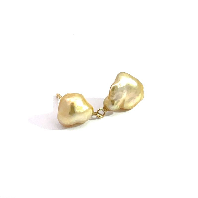 A pair of gold baroque pearl stud earrings with a small gold connector, shown on a plain white background.