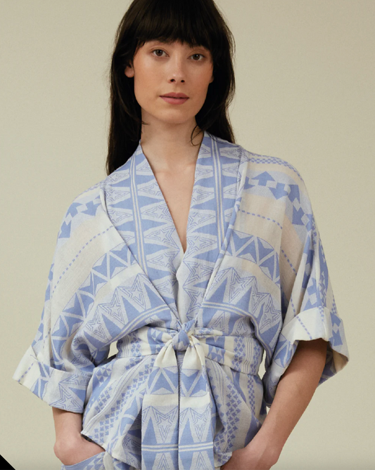 Woman weqaring Gloria blouse in blue and white by Tallulah & Hope.