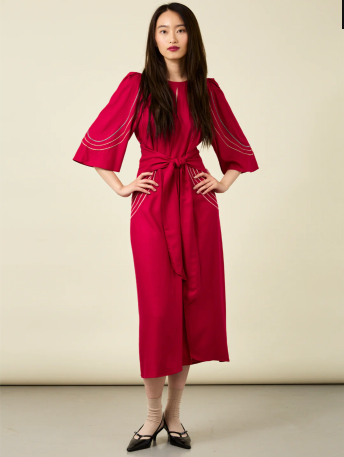 Woman with long hair wearing crimson red midi length dress