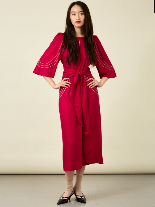 Woman with long hair wearing crimson red midi length dress