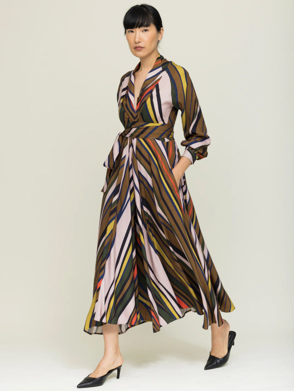 Woman wearing striped wrap dress in autumnal colors