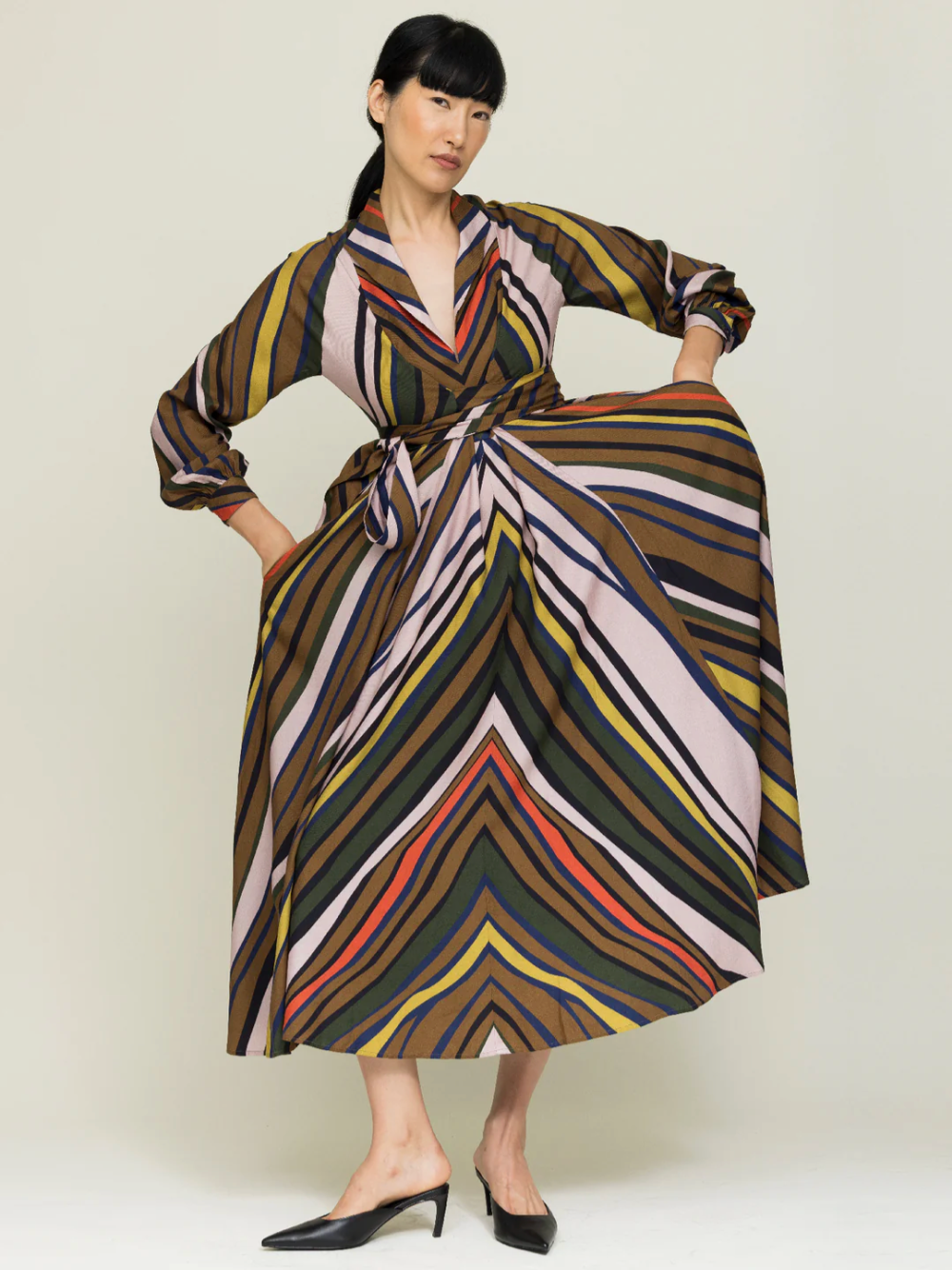 Woman wearing striped wrap dress in autumnal colors