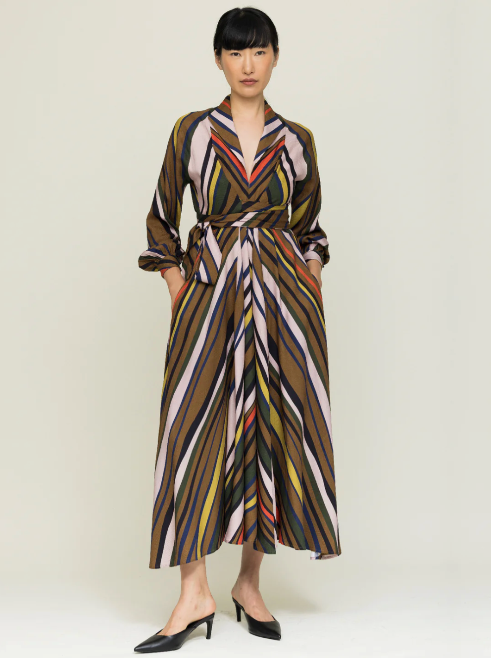 Woman wearing striped wrap dress in autumnal colors