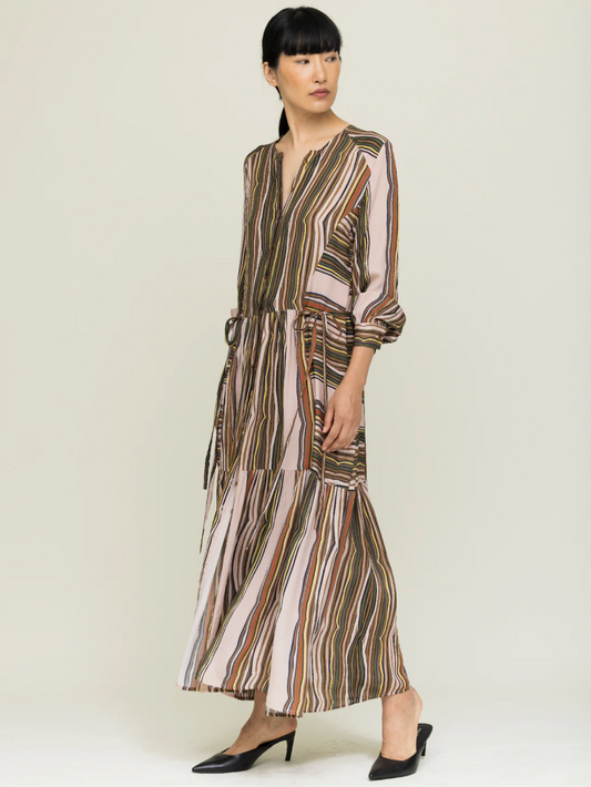 Woman wearing a striped dress on a plain background