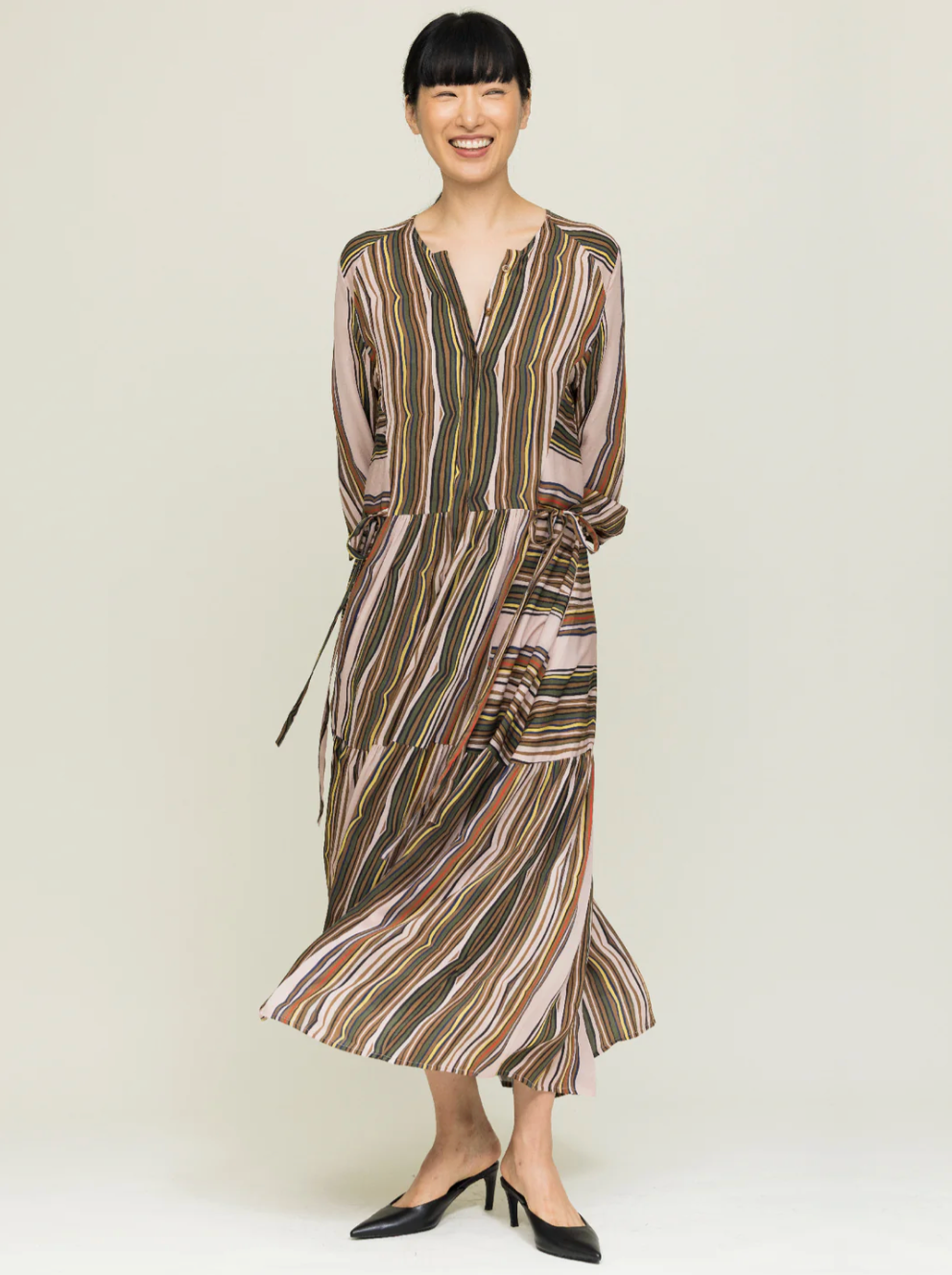 Woman wearing a patterned dress on a white background