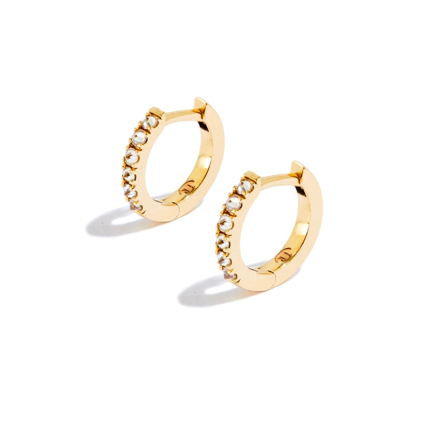 Tiny gold hoop earrings with white diamonds