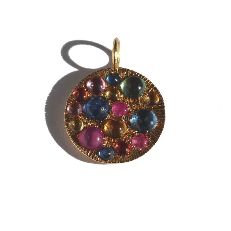 gold round pendant with multi colored gemstones