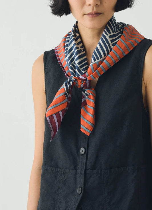 Block print Bandana worn over a navy vest with a white background