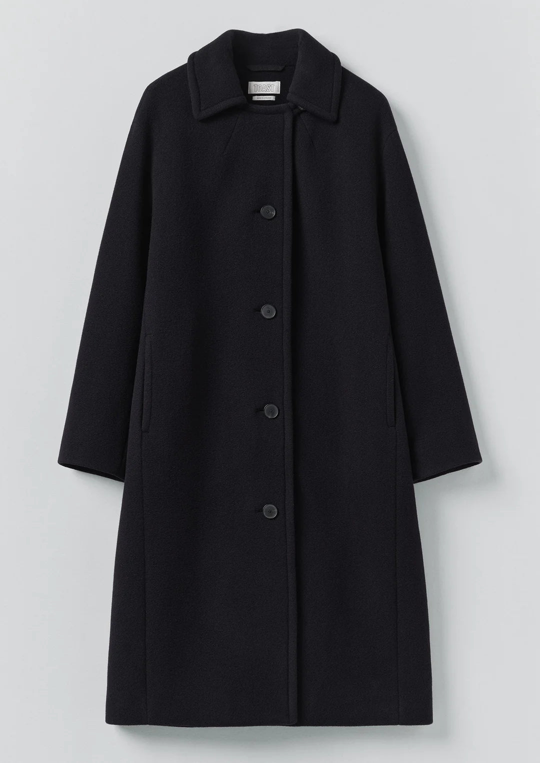Black coat with buttons on a light gray background