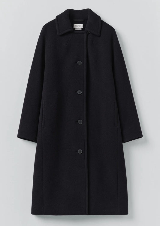 Black coat with buttons on a light gray background