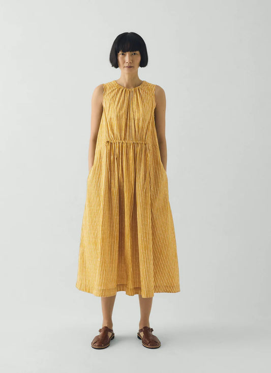 Woman wearing a yellow dress on a white background