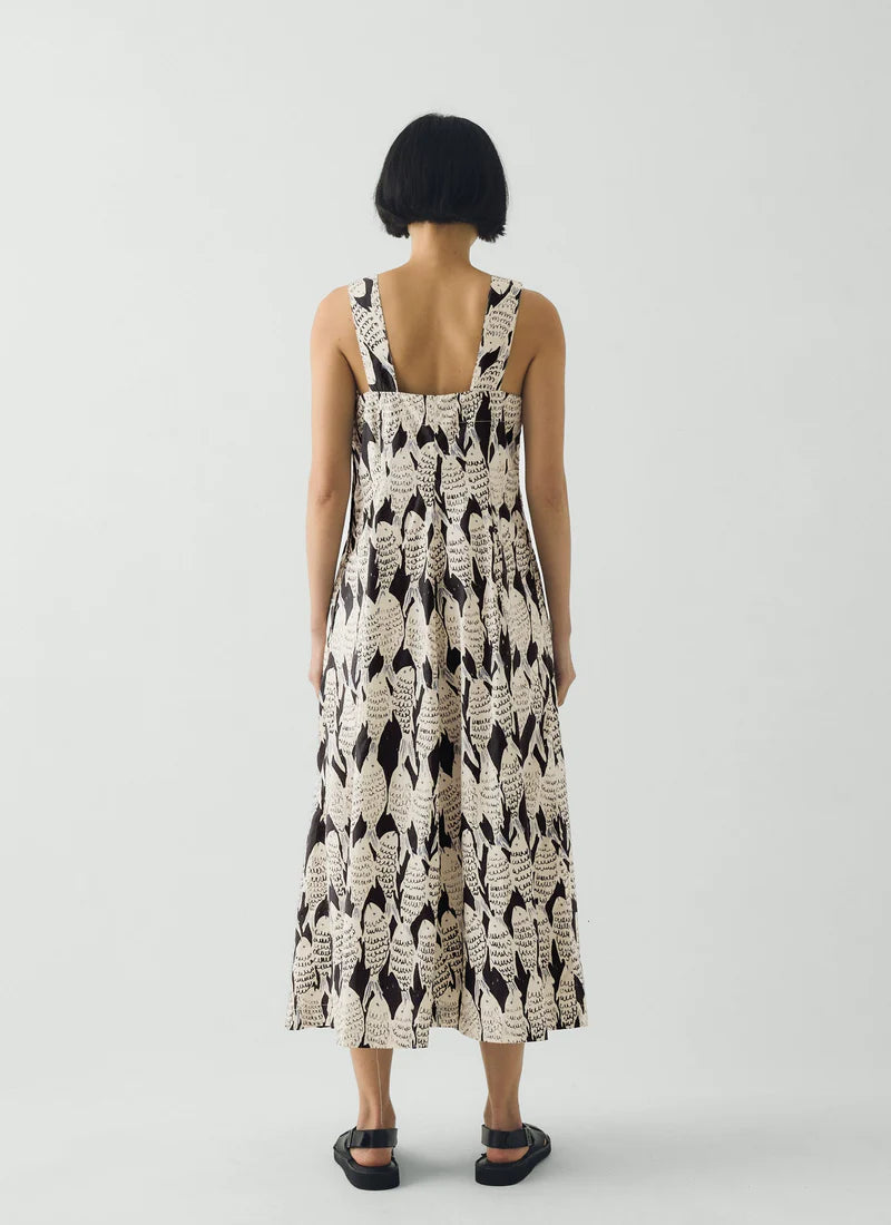 a sleeveless dress with a fish pattern on a plain background