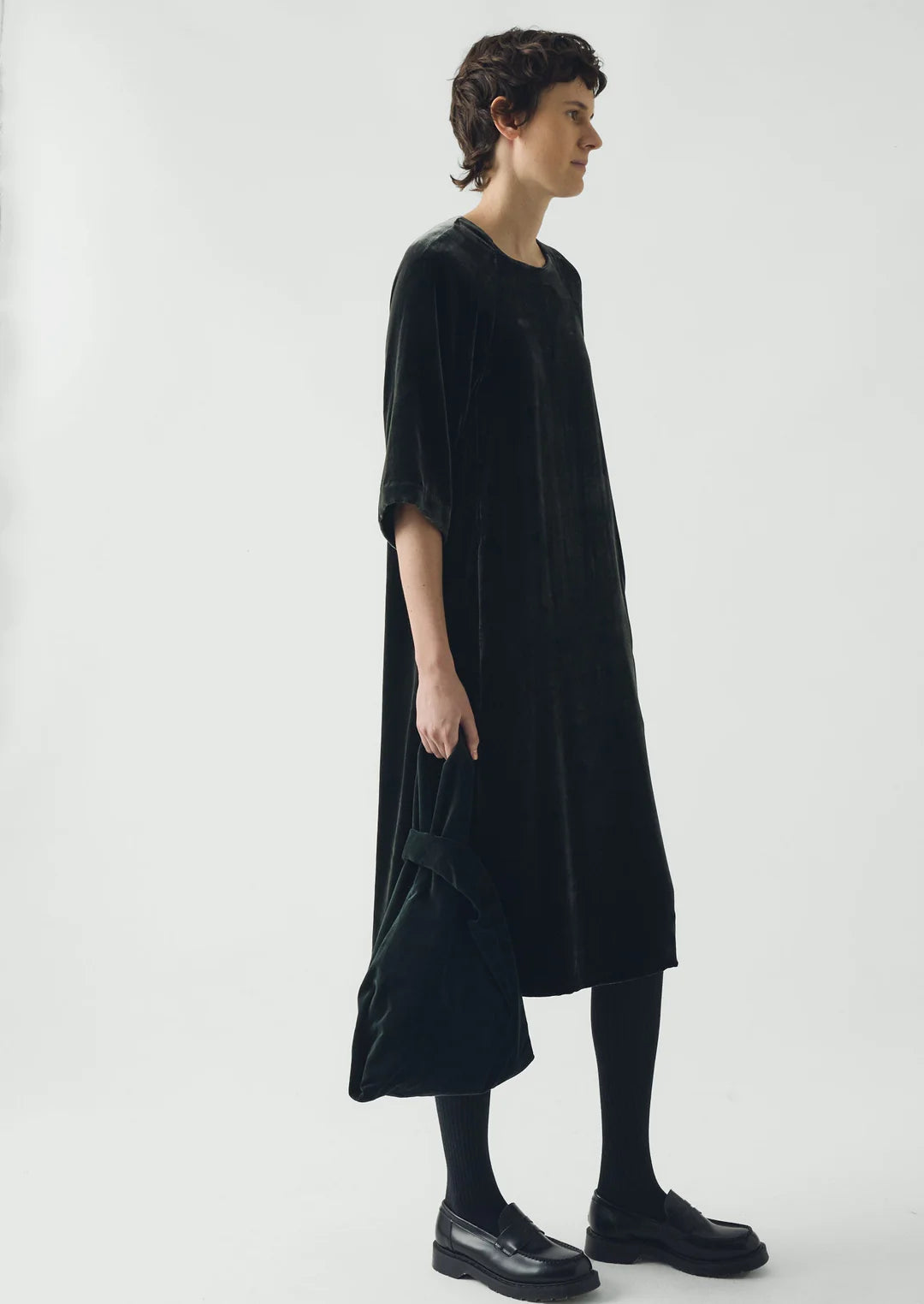 Person wearing a black dress on a white background