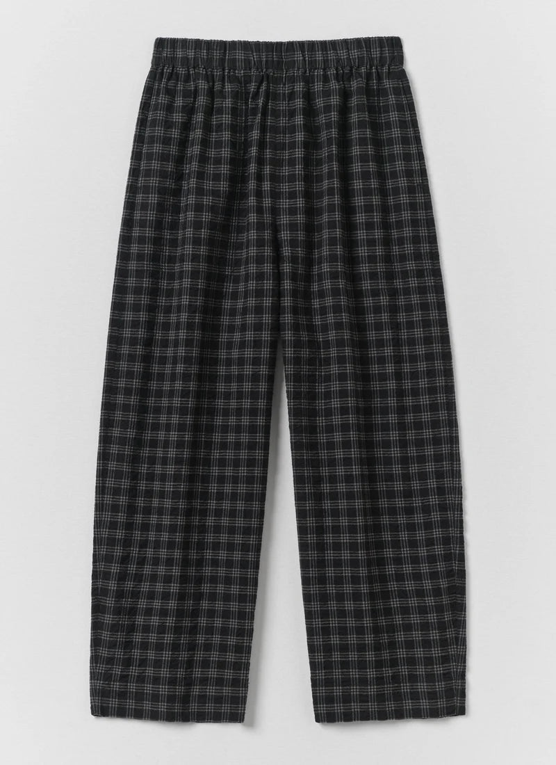Black and gray plaid lounge pants with an elastic waistband, shown flat against a light gray background.