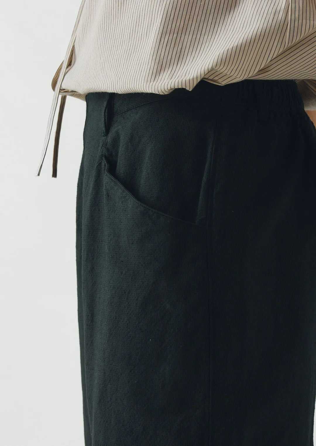 Dark green pants with a white background