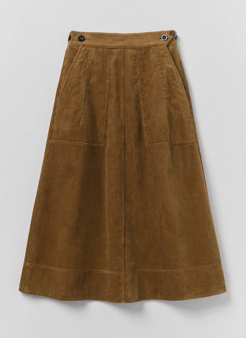 A golden amber corduroy skirt shown laying flat.