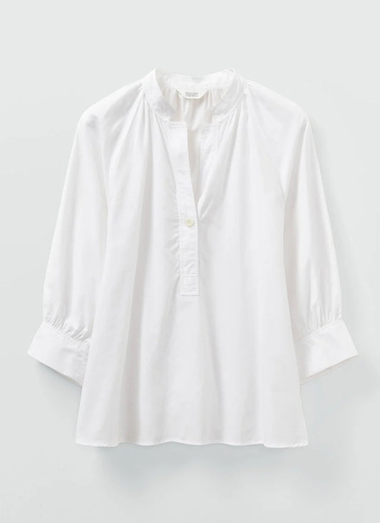 A white cotton oxford shirt shown laying flat.