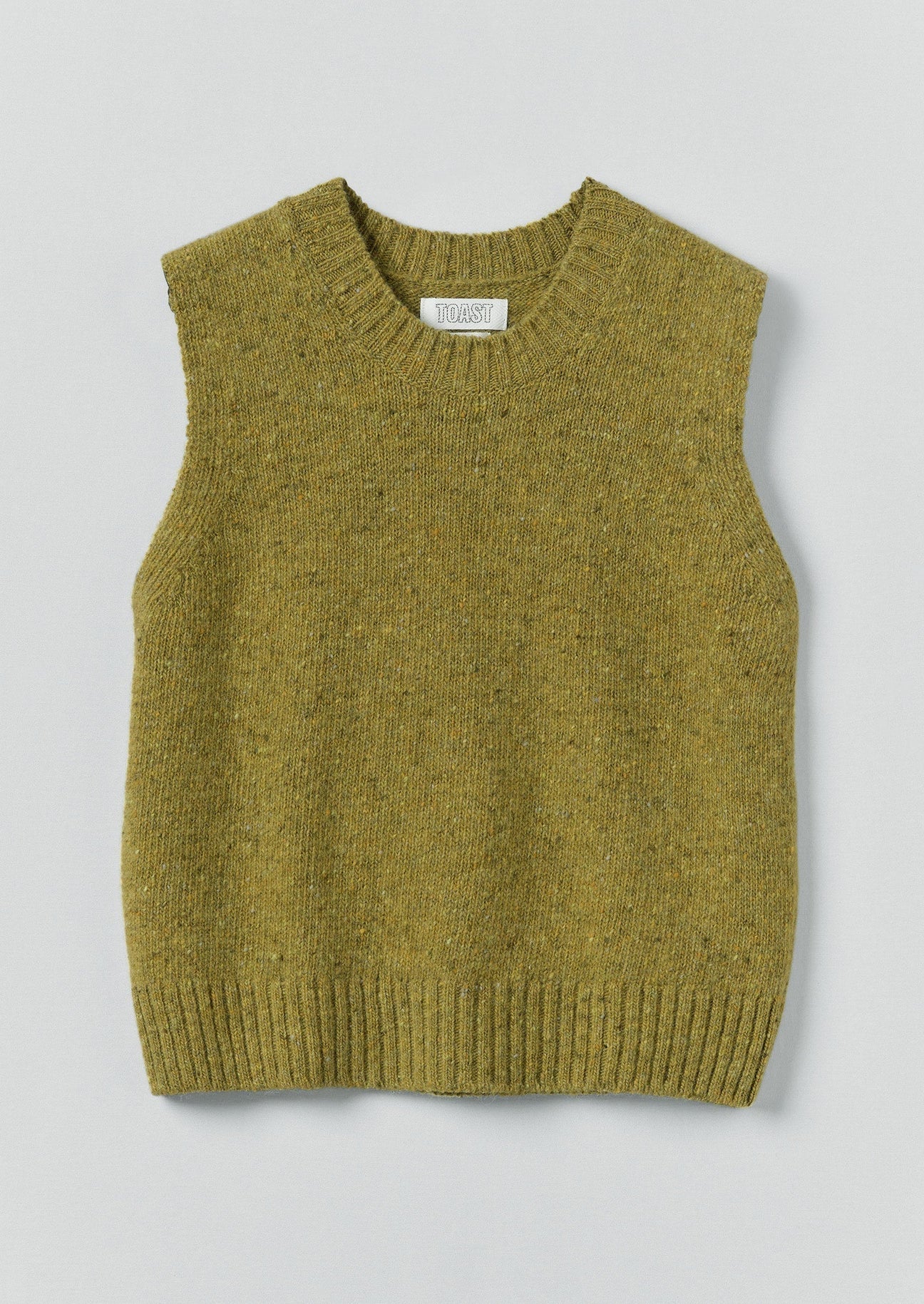 Green knitted vest on a light gray background