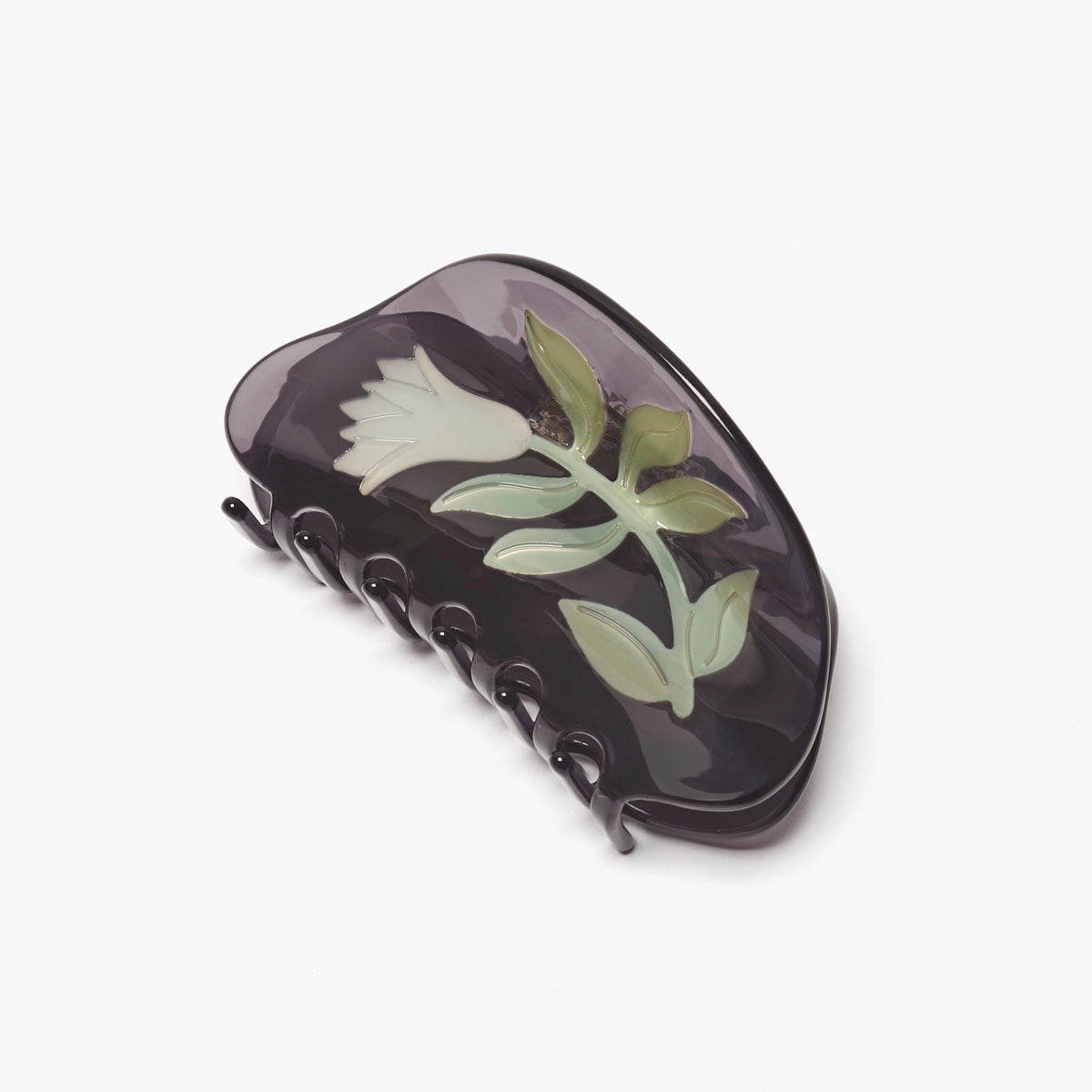 Black hair clip with floral design on a white background