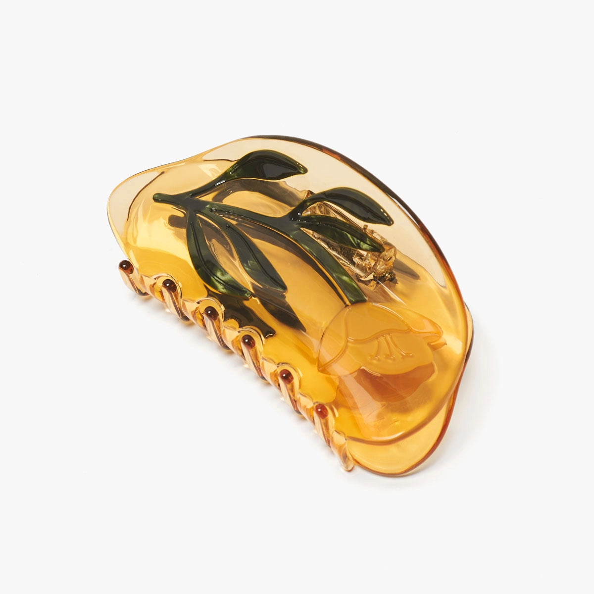 Yellow hair clip with floral design on a white background
