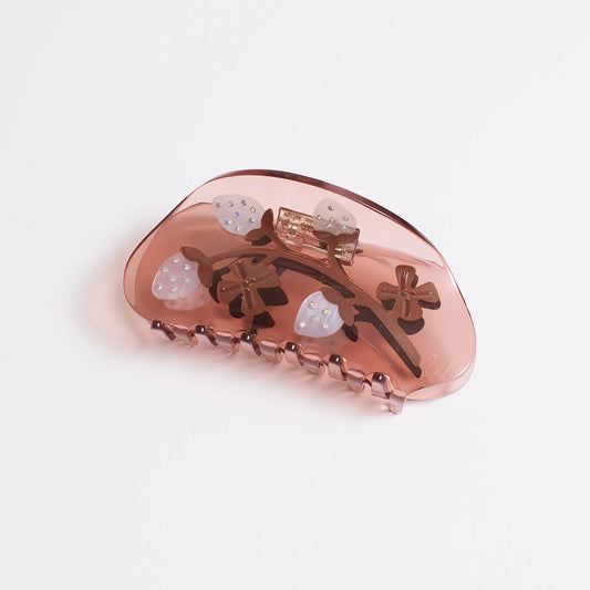 A translucent dusty rose hair claw clip decorated with white pineberries embellishes with sparkling seeds, shown on a clean white background.