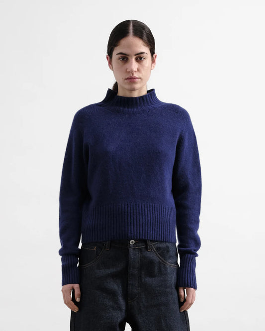 Person wearing a blue sweater on a white background