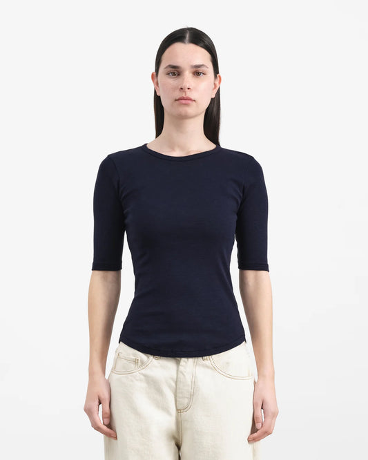Woman wearing a navy blue short-sleeve shirt on a white background