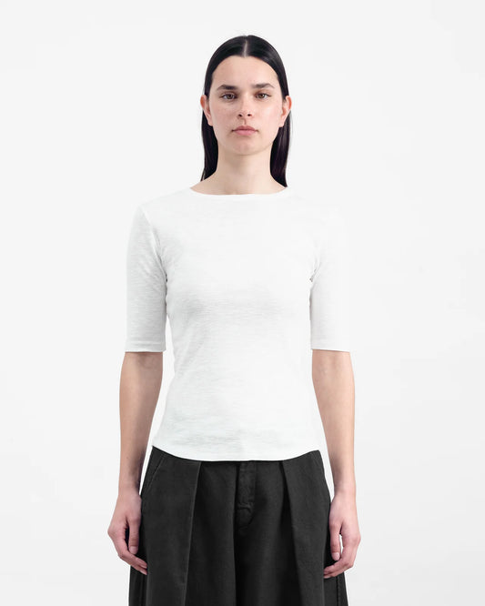 Person wearing a white short-sleeve shirt and black pants on a white background